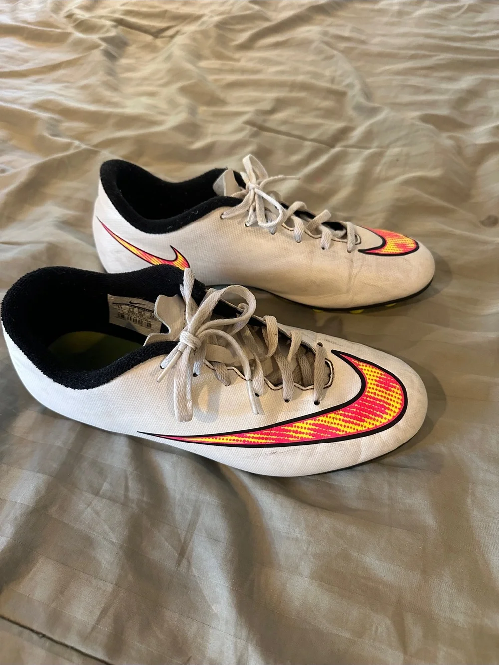Nike Kids White Soccer Cleats with Neon Yellow and Pink Swoosh